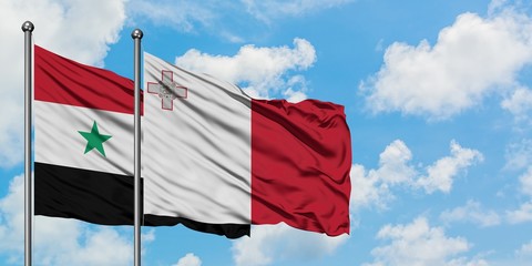 Syria and Malta flag waving in the wind against white cloudy blue sky together. Diplomacy concept,...