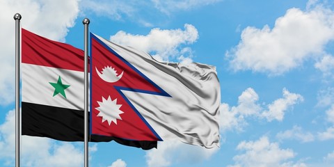 Syria and Nepal flag waving in the wind against white cloudy blue sky together. Diplomacy concept, international relations.