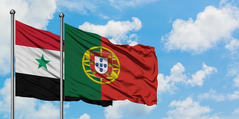Syria and Portugal flag waving in the wind against white cloudy blue sky together. Diplomacy concept, international relations.