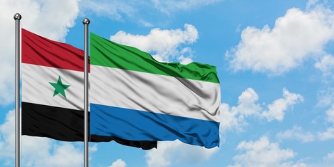 Syria and Sierra Leone flag waving in the wind against white cloudy blue sky together. Diplomacy...