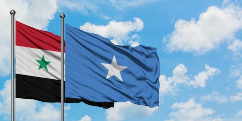 Syria and Somalia flag waving in the wind against white cloudy blue sky together. Diplomacy concept, international relations.
