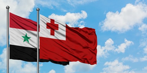 Syria and Tonga flag waving in the wind against white cloudy blue sky together. Diplomacy concept, international relations.