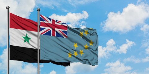 Syria and Tuvalu flag waving in the wind against white cloudy blue sky together. Diplomacy concept,...