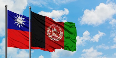 Taiwan and Afghanistan flag waving in the wind against white cloudy blue sky together. Diplomacy concept, international relations.