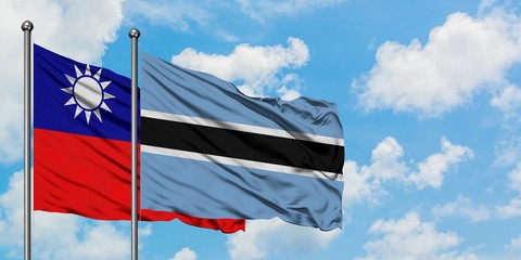 Taiwan and Botswana flag waving in the wind against white cloudy blue sky together. Diplomacy concept, international relations.