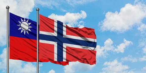 Taiwan and Bouvet Islands flag waving in the wind against white cloudy blue sky together. Diplomacy concept, international relations.