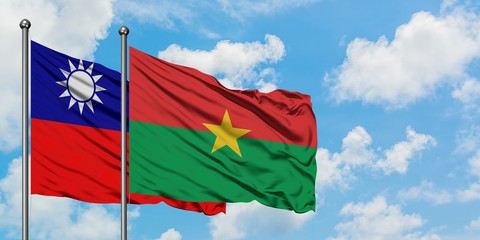 Naklejka na ściany i meble Taiwan and Burkina Faso flag waving in the wind against white cloudy blue sky together. Diplomacy concept, international relations.
