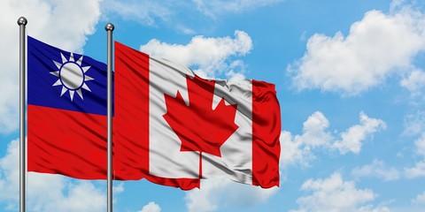 Taiwan and Canada flag waving in the wind against white cloudy blue sky together. Diplomacy concept, international relations.