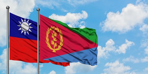 Taiwan and Eritrea flag waving in the wind against white cloudy blue sky together. Diplomacy concept, international relations.