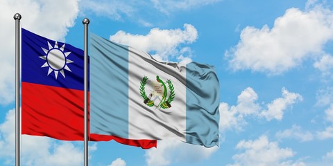 Taiwan and Guatemala flag waving in the wind against white cloudy blue sky together. Diplomacy concept, international relations.
