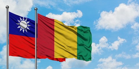 Taiwan and Guinea flag waving in the wind against white cloudy blue sky together. Diplomacy concept, international relations.