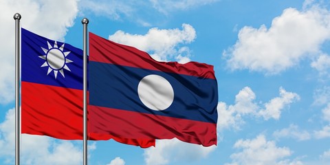 Taiwan and Laos flag waving in the wind against white cloudy blue sky together. Diplomacy concept, international relations.