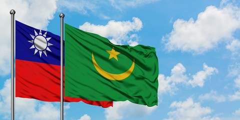 Taiwan and Mauritania flag waving in the wind against white cloudy blue sky together. Diplomacy concept, international relations.