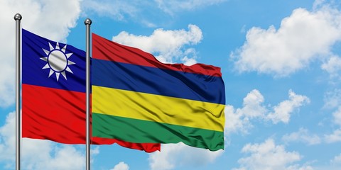 Taiwan and Mauritius flag waving in the wind against white cloudy blue sky together. Diplomacy concept, international relations.