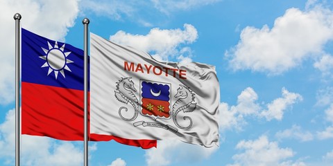 Taiwan and Mayotte flag waving in the wind against white cloudy blue sky together. Diplomacy concept, international relations.