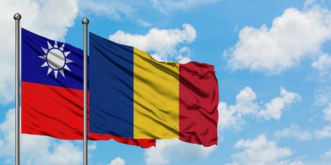 Taiwan and Romania flag waving in the wind against white cloudy blue sky together. Diplomacy concept, international relations.