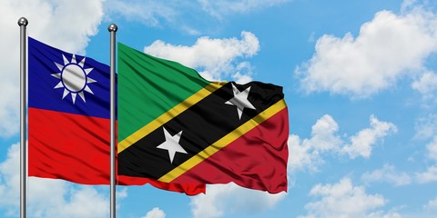 Naklejka na ściany i meble Taiwan and Saint Kitts And Nevis flag waving in the wind against white cloudy blue sky together. Diplomacy concept, international relations.