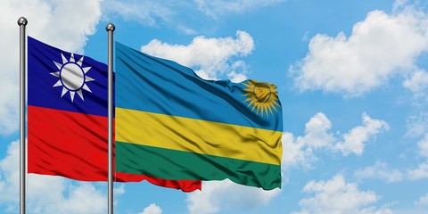Taiwan and Rwanda flag waving in the wind against white cloudy blue sky together. Diplomacy concept, international relations.