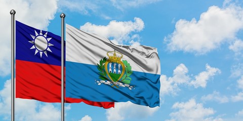 Taiwan and San Marino flag waving in the wind against white cloudy blue sky together. Diplomacy concept, international relations.