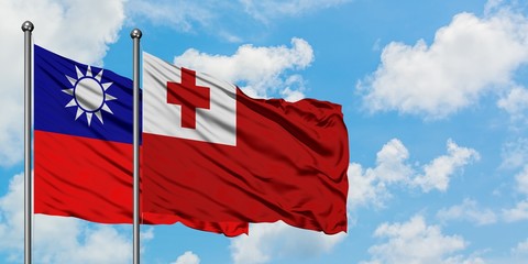 Taiwan and Tonga flag waving in the wind against white cloudy blue sky together. Diplomacy concept, international relations.