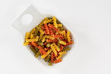 Raw colored pasta dish made with vegetables to boil and serve aldente