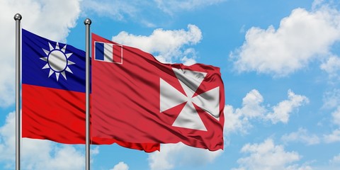 Taiwan and Wallis And Futuna flag waving in the wind against white cloudy blue sky together. Diplomacy concept, international relations.