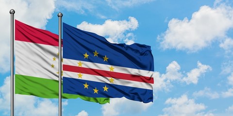 Tajikistan and Cape Verde flag waving in the wind against white cloudy blue sky together. Diplomacy concept, international relations.