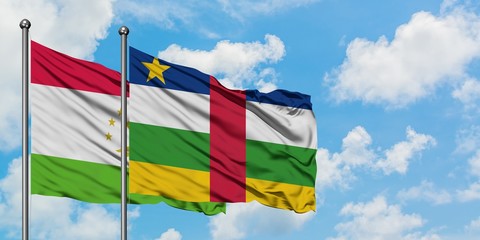 Tajikistan and Central African Republic flag waving in the wind against white cloudy blue sky together. Diplomacy concept, international relations.