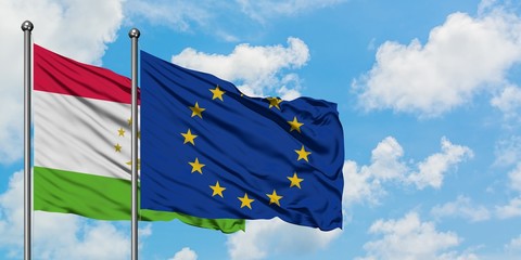 Tajikistan and European Union flag waving in the wind against white cloudy blue sky together. Diplomacy concept, international relations.
