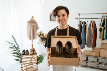 Confident young businessman working at online business store. Small business owner at his workshop