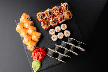 Various kinds of sushi served on black background. Sushi menu for Japanese food. Japanese sushi...
