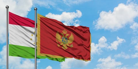 Tajikistan and Montenegro flag waving in the wind against white cloudy blue sky together. Diplomacy concept, international relations.