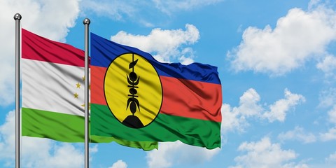 Tajikistan and New Caledonia flag waving in the wind against white cloudy blue sky together. Diplomacy concept, international relations.