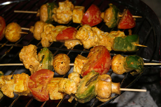 brochettes of veges cooking on barbecue