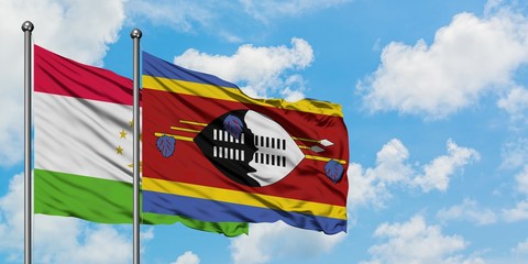 Tajikistan and Swaziland flag waving in the wind against white cloudy blue sky together. Diplomacy concept, international relations.