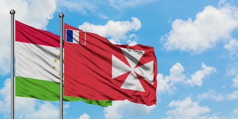 Tajikistan and Wallis And Futuna flag waving in the wind against white cloudy blue sky together. Diplomacy concept, international relations.
