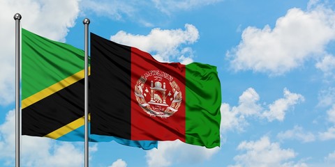 Tanzania and Afghanistan flag waving in the wind against white cloudy blue sky together. Diplomacy concept, international relations.