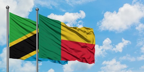 Tanzania and Benin flag waving in the wind against white cloudy blue sky together. Diplomacy concept, international relations.