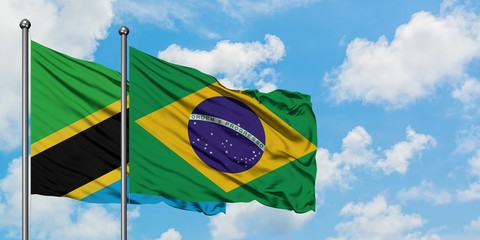 Tanzania and Brazil flag waving in the wind against white cloudy blue sky together. Diplomacy concept, international relations.