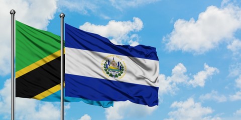 Tanzania and El Salvador flag waving in the wind against white cloudy blue sky together. Diplomacy concept, international relations.