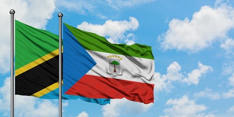 Tanzania and Equatorial Guinea flag waving in the wind against white cloudy blue sky together. Diplomacy concept, international relations.
