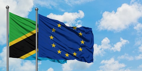 Tanzania and European Union flag waving in the wind against white cloudy blue sky together. Diplomacy concept, international relations.