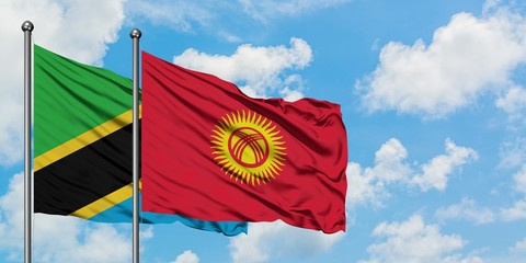 Tanzania and Kyrgyzstan flag waving in the wind against white cloudy blue sky together. Diplomacy concept, international relations.