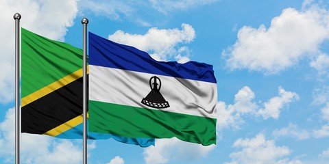 Tanzania and Lesotho flag waving in the wind against white cloudy blue sky together. Diplomacy concept, international relations.