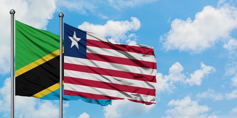 Tanzania and Liberia flag waving in the wind against white cloudy blue sky together. Diplomacy concept, international relations.