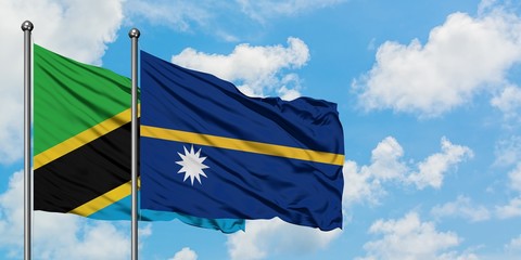 Tanzania and Nauru flag waving in the wind against white cloudy blue sky together. Diplomacy concept, international relations.