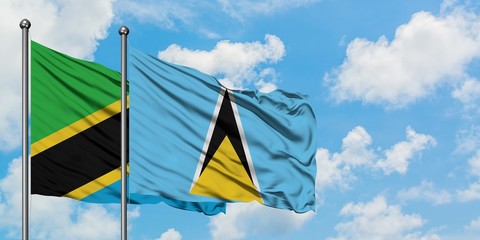 Tanzania and Saint Lucia flag waving in the wind against white cloudy blue sky together. Diplomacy concept, international relations.