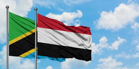 Tanzania and Yemen flag waving in the wind against white cloudy blue sky together. Diplomacy concept, international relations.