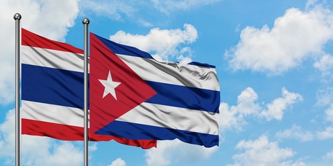 Thailand and Cuba flag waving in the wind against white cloudy blue sky together. Diplomacy concept, international relations.