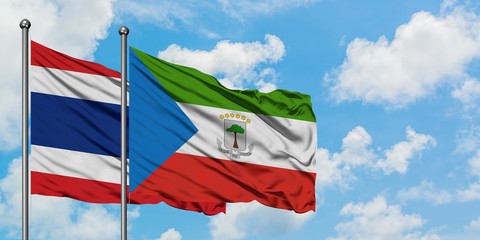 Thailand and Equatorial Guinea flag waving in the wind against white cloudy blue sky together. Diplomacy concept, international relations.